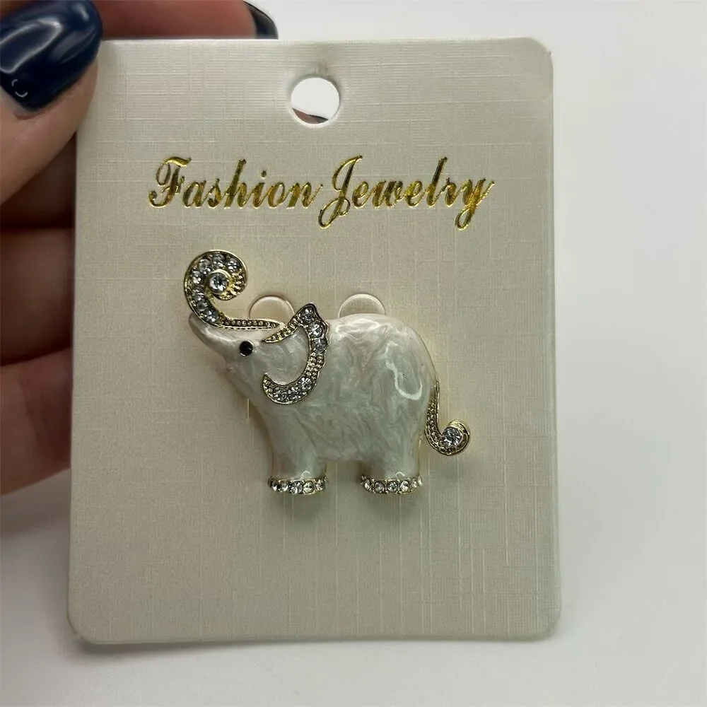 Small Dainty White Elephant Brooch Pin Rhinestone Accents Gold Tone Trunk Up